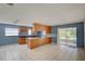 Spacious kitchen featuring wood cabinets, a center island, and access to the outdoor patio at 422 S Hawthorn Cir, Winter Springs, FL 32708