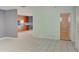 Open-concept living space with tiled floors and a view into the kitchen area at 422 S Hawthorn Cir, Winter Springs, FL 32708