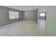 Bright living room with tiled floors, large windows, and access to the kitchen at 422 S Hawthorn Cir, Winter Springs, FL 32708