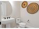 Chic powder room with pedestal sink, decorative wall art, and modern fixtures at 5101 Rising Ridge Dr, Mount Dora, FL 32757