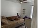 This cozy bedroom features a ceiling fan and natural light from the window at 5118 Laval Dr, Orlando, FL 32839