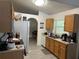 A well-lit kitchen with light wood cabinets, white appliances, and tile flooring at 5118 Laval Dr, Orlando, FL 32839