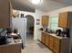 A well-lit kitchen with light wood cabinets, white appliances, and tile flooring at 5118 Laval Dr, Orlando, FL 32839
