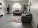 A modern living room showcasing couches, area rug and a large arched window for natural light at 5118 Laval Dr, Orlando, FL 32839