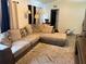 A cozy living room featuring a plush sectional sofa and neutral-toned decor at 5118 Laval Dr, Orlando, FL 32839