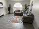 A modern living room showcasing couches, area rug and a large arched window for natural light at 5118 Laval Dr, Orlando, FL 32839