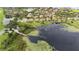 Aerial view shows a lakefront community with lily pads, docks, and a variety of homes at 5669 New Independence Pkwy, Winter Garden, FL 34787