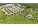 Aerial view shows playground, grassy areas, trees, walking paths, and parking in a park at 5669 New Independence Pkwy, Winter Garden, FL 34787