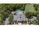Community center features a swimming pool, lounge chairs, parking and lake in aerial view at 5669 New Independence Pkwy, Winter Garden, FL 34787