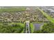 Aerial view features sidewalks, driveways, ponds, lush landscaping, and green space in neighborhood at 5669 New Independence Pkwy, Winter Garden, FL 34787