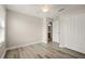 Comfortable bedroom featuring wood-look floors, ceiling fan, closet, and ensuite access at 5669 New Independence Pkwy, Winter Garden, FL 34787