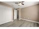 Comfortable bedroom featuring wood-look floors, ceiling fan, and closet at 5669 New Independence Pkwy, Winter Garden, FL 34787