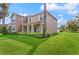 Well maintained two-story home showcasing a manicured lawn with palm trees and inviting curb appeal at 5669 New Independence Pkwy, Winter Garden, FL 34787