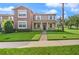 Inviting two-story home featuring a well-maintained lawn, charming entryway, and neutral-tone facade at 5669 New Independence Pkwy, Winter Garden, FL 34787