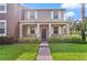 Charming two-story home with a welcoming front porch, lush green lawn, and meticulously manicured landscaping at 5669 New Independence Pkwy, Winter Garden, FL 34787