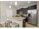 Beautiful kitchen with a granite island, dark wood cabinets, stainless steel appliances, and pendant lighting at 5669 New Independence Pkwy, Winter Garden, FL 34787