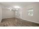 Bright living room featuring wood-look floors, a ceiling fan, and ample natural light through multiple windows at 5669 New Independence Pkwy, Winter Garden, FL 34787