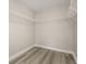 Walk-in closet with wire shelves and wood-look flooring at 5669 New Independence Pkwy, Winter Garden, FL 34787