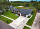Expansive aerial view of a single-story home featuring a lush lawn, mature trees, and a private driveway at 5938 Marlberry Dr, Orlando, FL 32819