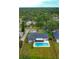 Beautiful aerial view of a home with a private pool surrounded by mature trees and lush greenery at 5938 Marlberry Dr, Orlando, FL 32819