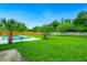 Expansive backyard with a private swimming pool surrounded by lush greenery, offering a serene outdoor retreat at 5938 Marlberry Dr, Orlando, FL 32819