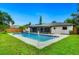 Lush backyard with a sparkling pool, screened-in patio, and a charming home exterior, perfect for outdoor living at 5938 Marlberry Dr, Orlando, FL 32819