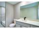 Renovated bathroom featuring tub with glass surround, updated vanity, and toilet at 5938 Marlberry Dr, Orlando, FL 32819