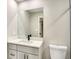 Modern bathroom with a white vanity, sleek fixtures, and a large mirror at 5938 Marlberry Dr, Orlando, FL 32819