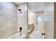 Remodeled bathroom with shower, tub, tile surround, and gray vanity at 5938 Marlberry Dr, Orlando, FL 32819