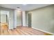 An empty bedroom showcases new wood flooring, closet, and access to other rooms at 5938 Marlberry Dr, Orlando, FL 32819
