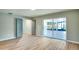 Open-concept bedroom featuring wood floors, neutral walls and a sliding door to the outside at 5938 Marlberry Dr, Orlando, FL 32819