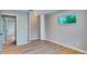 A bedroom featuring new wood flooring and a closet with bifold doors at 5938 Marlberry Dr, Orlando, FL 32819