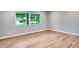 An empty bedroom showcases new wood flooring and a large window at 5938 Marlberry Dr, Orlando, FL 32819