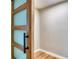 A modern sliding barn door reveals a tidy closet space with neutral wall color and wood flooring at 5938 Marlberry Dr, Orlando, FL 32819