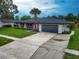 Single-story home featuring a well-maintained lawn, private driveway, and attached garage at 5938 Marlberry Dr, Orlando, FL 32819
