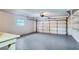 Spacious garage with white walls, concrete floors, window, and built-in shelving perfect for storage and organization at 5938 Marlberry Dr, Orlando, FL 32819