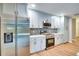 Updated kitchen with stainless steel appliances, modern backsplash, and new cabinets, creating a sleek and functional space at 5938 Marlberry Dr, Orlando, FL 32819