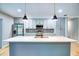 Bright kitchen featuring modern island with pendant lighting, stainless steel appliances, and ample cabinet space at 5938 Marlberry Dr, Orlando, FL 32819