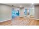 An open-concept living room boasts wood floors and a view of the kitchen and patio at 5938 Marlberry Dr, Orlando, FL 32819