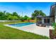 Backyard with a private swimming pool, a screened-in lanai, lush green grass, and a wood fence for added privacy at 5938 Marlberry Dr, Orlando, FL 32819