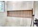 This modern shower is equipped with built-in shelving, a hand held sprayer, and a rain shower head at 5938 Marlberry Dr, Orlando, FL 32819