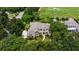 Stunning aerial view of a large home with meticulous landscaping, golf course frontage, and mature tree coverage at 6138 Greatwater Dr, Windermere, FL 34786