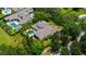 Aerial shot highlighting property amidst lush greenery, mature trees, and the lake visible in the distance at 6138 Greatwater Dr, Windermere, FL 34786