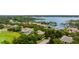 Beautiful elevated community shot with mature trees, manicured golf course, lush landscaping, and lake views at 6138 Greatwater Dr, Windermere, FL 34786