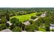 Extensive golf course community shot showcasing lake views, lush trees, multiple single Gathering homes, and manicured landscaping at 6138 Greatwater Dr, Windermere, FL 34786