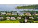 Aerial view of luxury homes with lush landscaping, serene lake views, and a golf course nearby at 6138 Greatwater Dr, Windermere, FL 34786