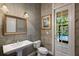 Powder room featuring pedestal sink and a window door viewing the pool area at 6138 Greatwater Dr, Windermere, FL 34786
