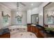 Primary bathroom featuring dual vanities, granite countertops, and a luxurious soaking tub at 6138 Greatwater Dr, Windermere, FL 34786