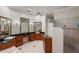 Bathroom featuring dual vanities, granite countertops, and a walk-in shower at 6138 Greatwater Dr, Windermere, FL 34786