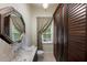 Bathroom featuring an elegant mirror, window, toilet, and dark brown cabinets for storage at 6138 Greatwater Dr, Windermere, FL 34786
